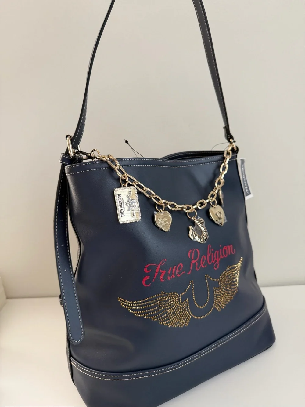 True Religion Navy Shoulder Bag with Gold Charm Chain and Red Logo